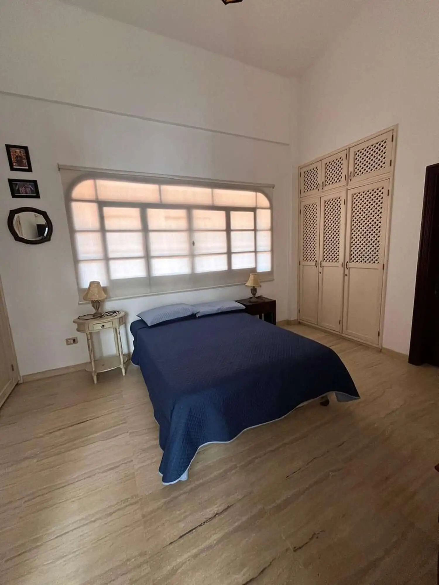 Comfortable bedroom featuring a large window, wardrobe, and minimalist decor on Margarita Island.