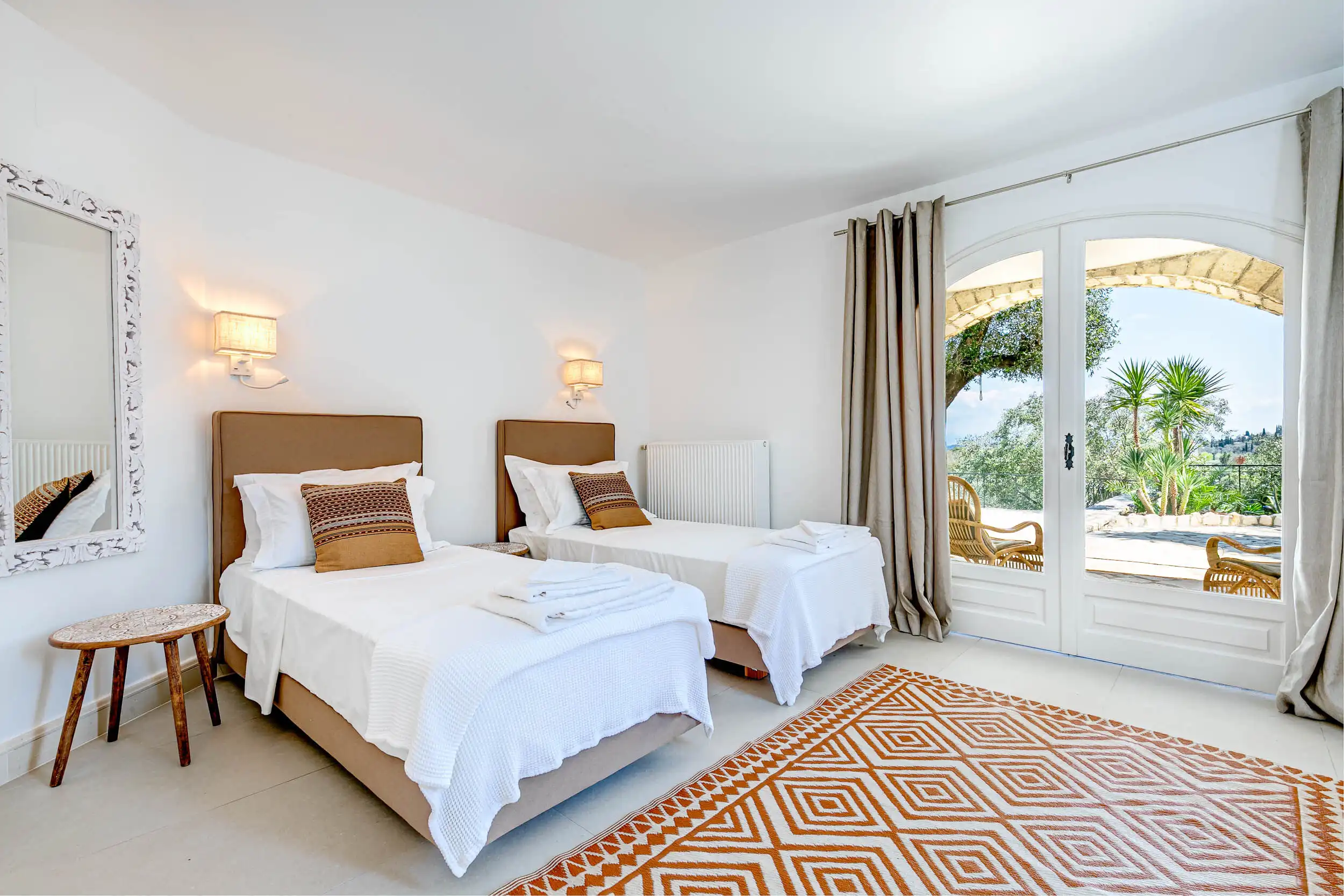 Luxury Villa Bedroom with Sea View in Corfu View bedroom in a luxury villa near Gouvia, Corfu, with modern decor and balcony overlooking lush gr.