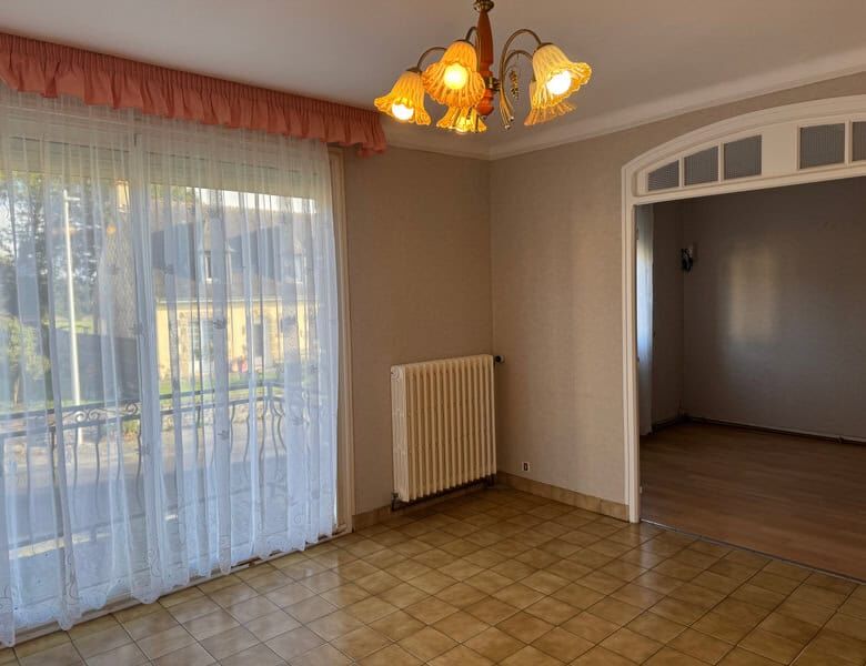Bright living room with large window and natural light, perfect for family living.