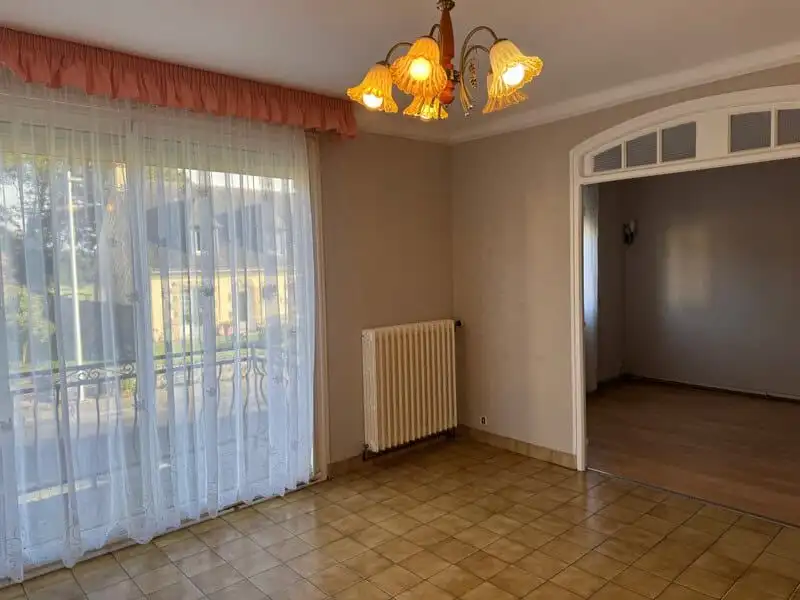 Bright living room with large window and natural light, perfect for family living.