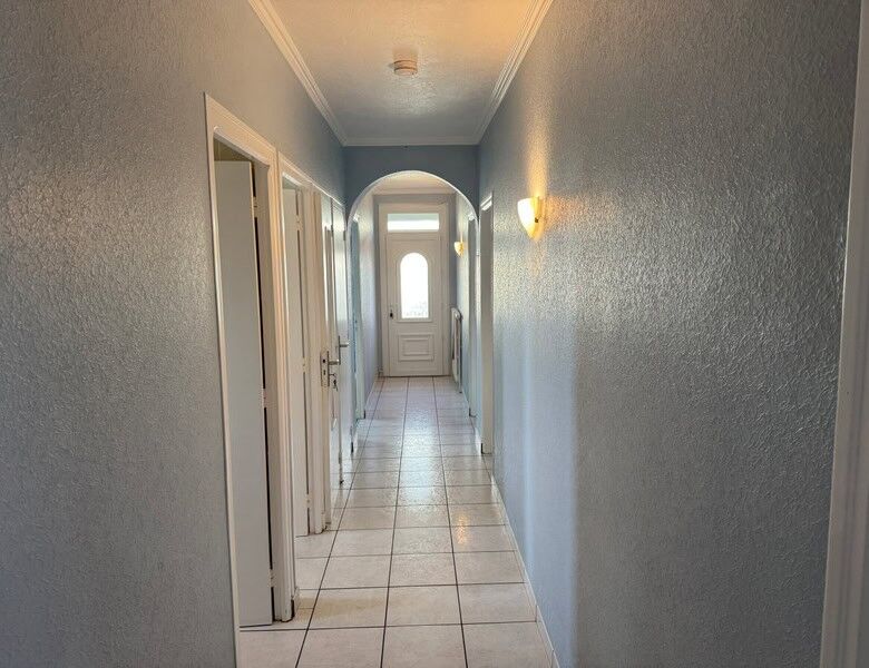 Bright hallway of a 2-bedroom house in Bon Repos Sur Blavet, Brittany, with tiled floors and soft li.