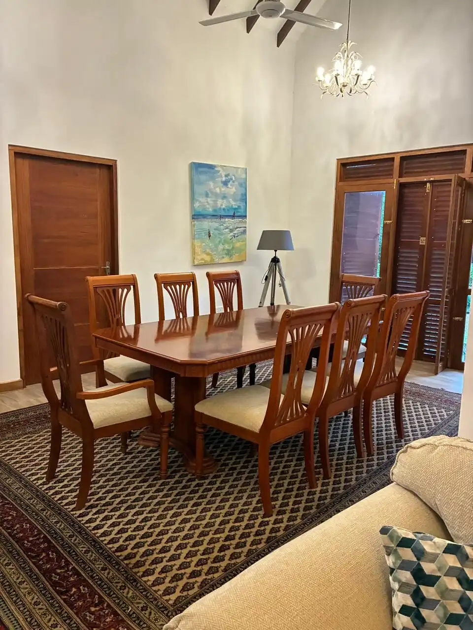 Spacious dining area featuring a large wooden table and eight chairs, perfect for family gatherings.