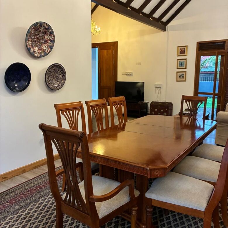 Elegant dining room featuring a wooden table, chairs, and wall decor in a cozy home setting.