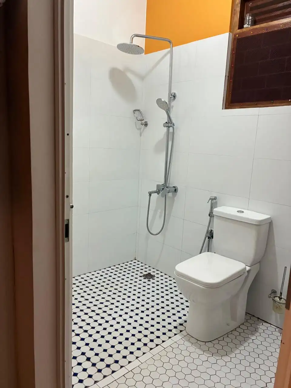 Bathroom with shower, toilet, and white tiles in Waikkal estate.