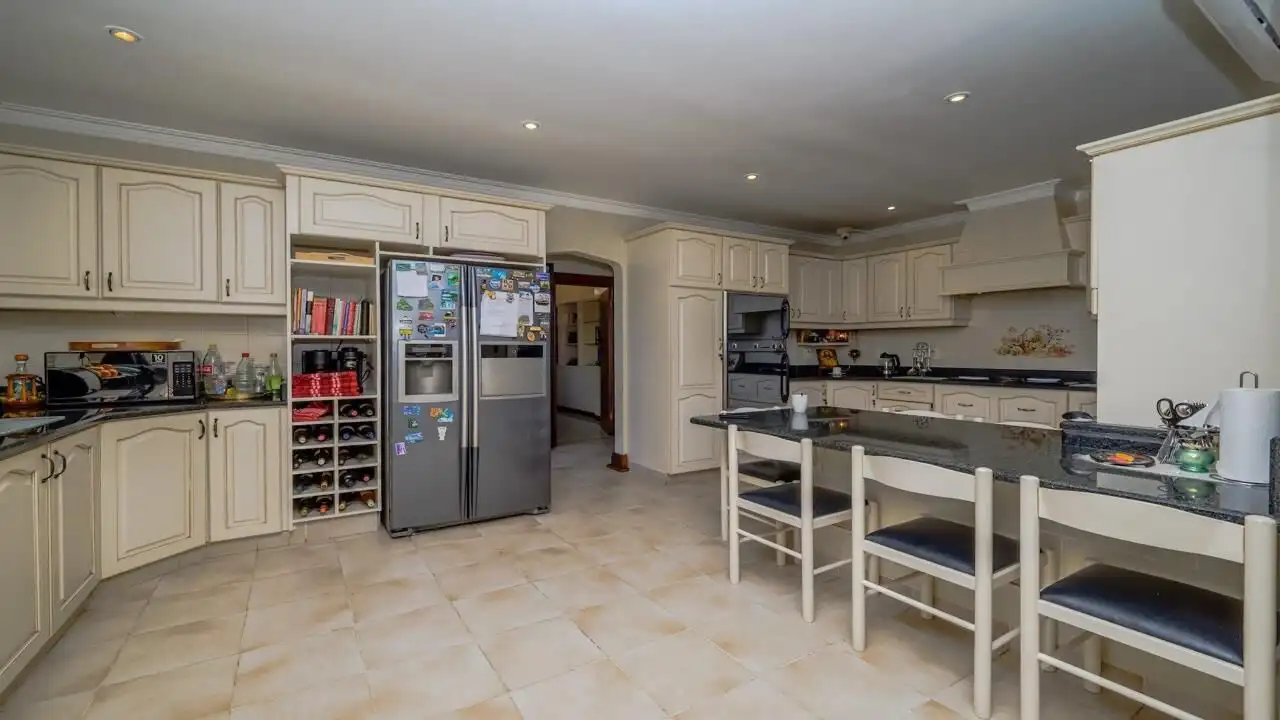 Spacious kitchen of a luxury 9-bedroom estate in Durban South, featuring modern appliances and ample.