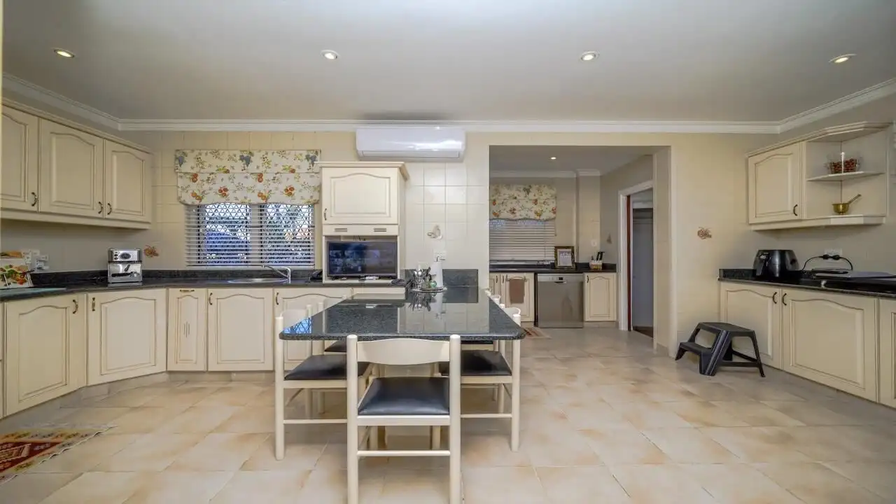 Spacious kitchen with modern appliances in a luxurious Durban estate. Perfect for family living and.