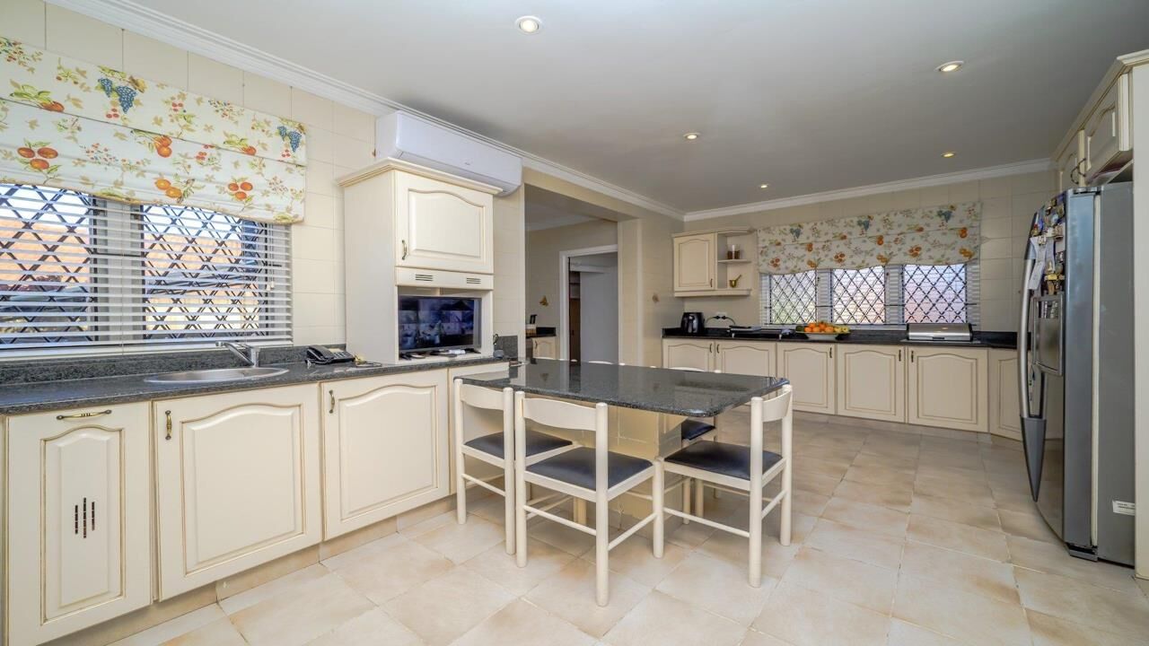 Luxury 9-Bed Estate in Durban South Elegant kitchen of a luxury 9-bedroom estate in Durban South, featuring spacious cabinetry and moder.