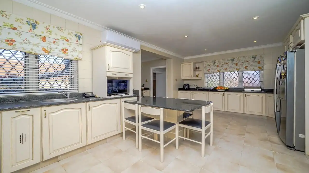 Elegant kitchen of a luxury 9-bedroom estate in Durban South, featuring spacious cabinetry and moder.
