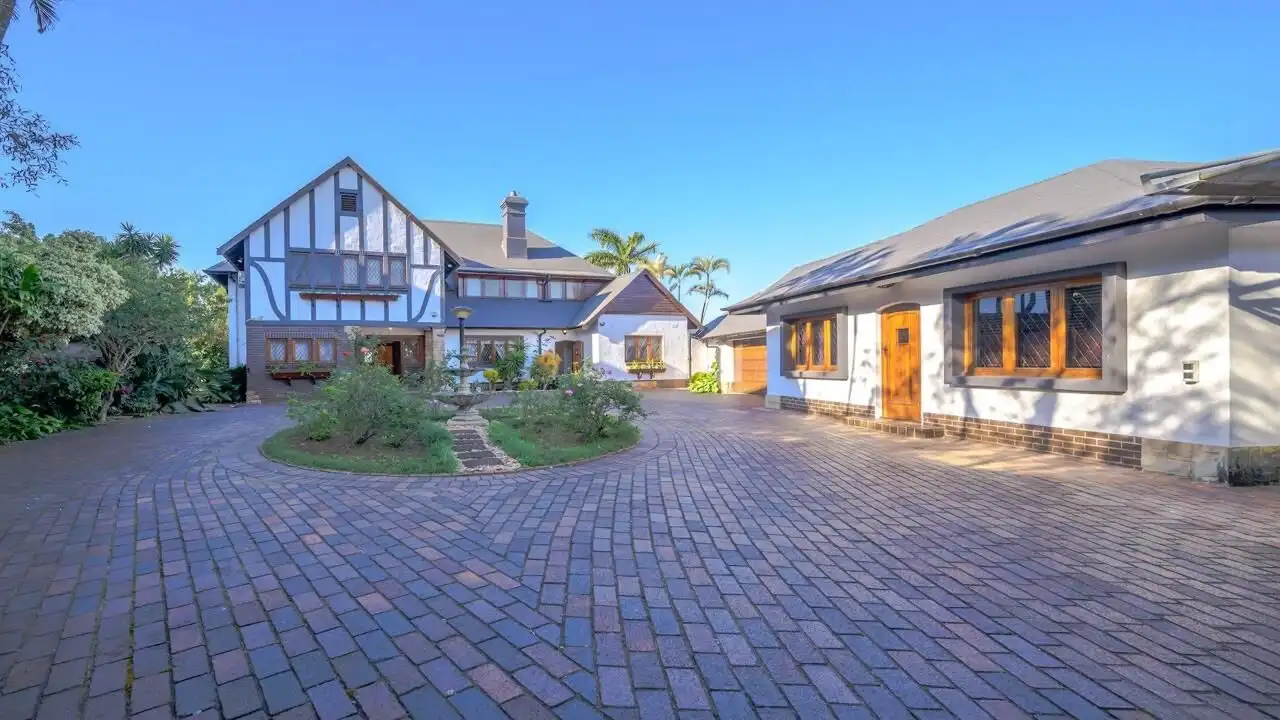 Spacious 9-bedroom estate for sale in Durban South with lush gardens and elegant architecture.