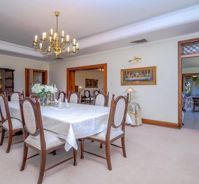 Elegant dining room in a luxury Durban estate with a large table and classic decor.