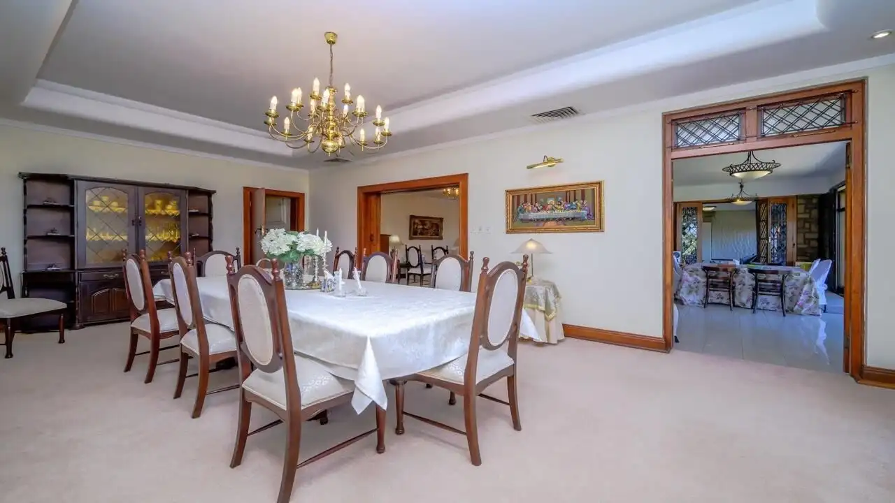 Elegant dining room in a luxury Durban estate with a large table and classic decor.
