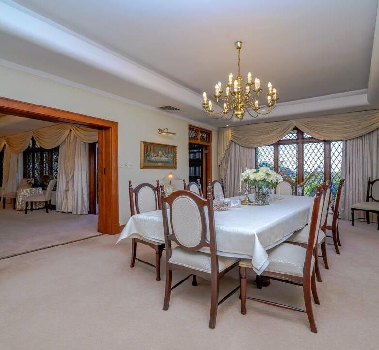Elegant dining room with classic decor and chandelier in Durban estate.