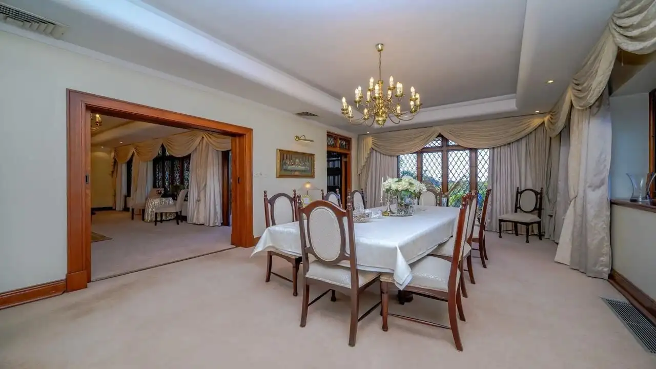 Elegant dining room with classic decor and chandelier in Durban estate.