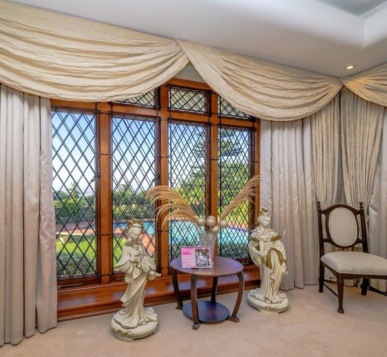 Elegant living room with large windows and classic decor in Durban estate.