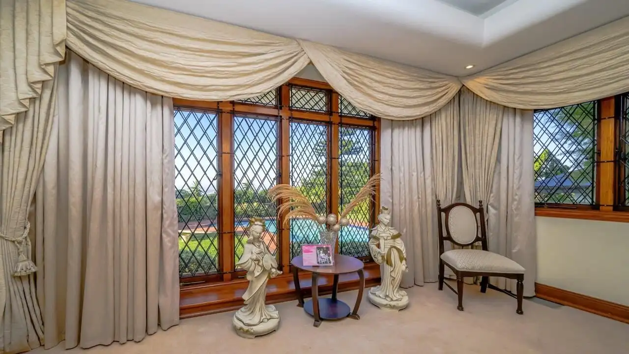 Elegant living room with large windows and classic decor in Durban estate.