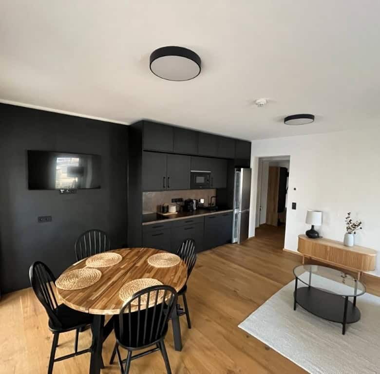 Modern Rattendorf apartment interior with dining area and kitchen.
