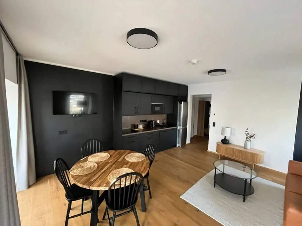 Modern Rattendorf apartment interior with dining area and kitchen.