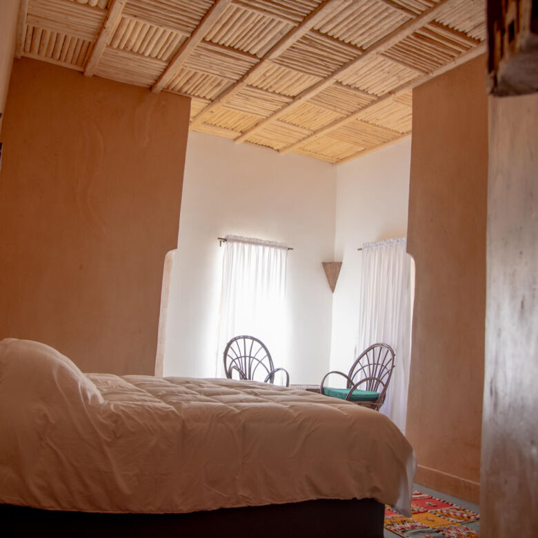 Bedroom at Kasbah Tiziri Hotel in Imzough, featuring traditional decor and natural lighting.
