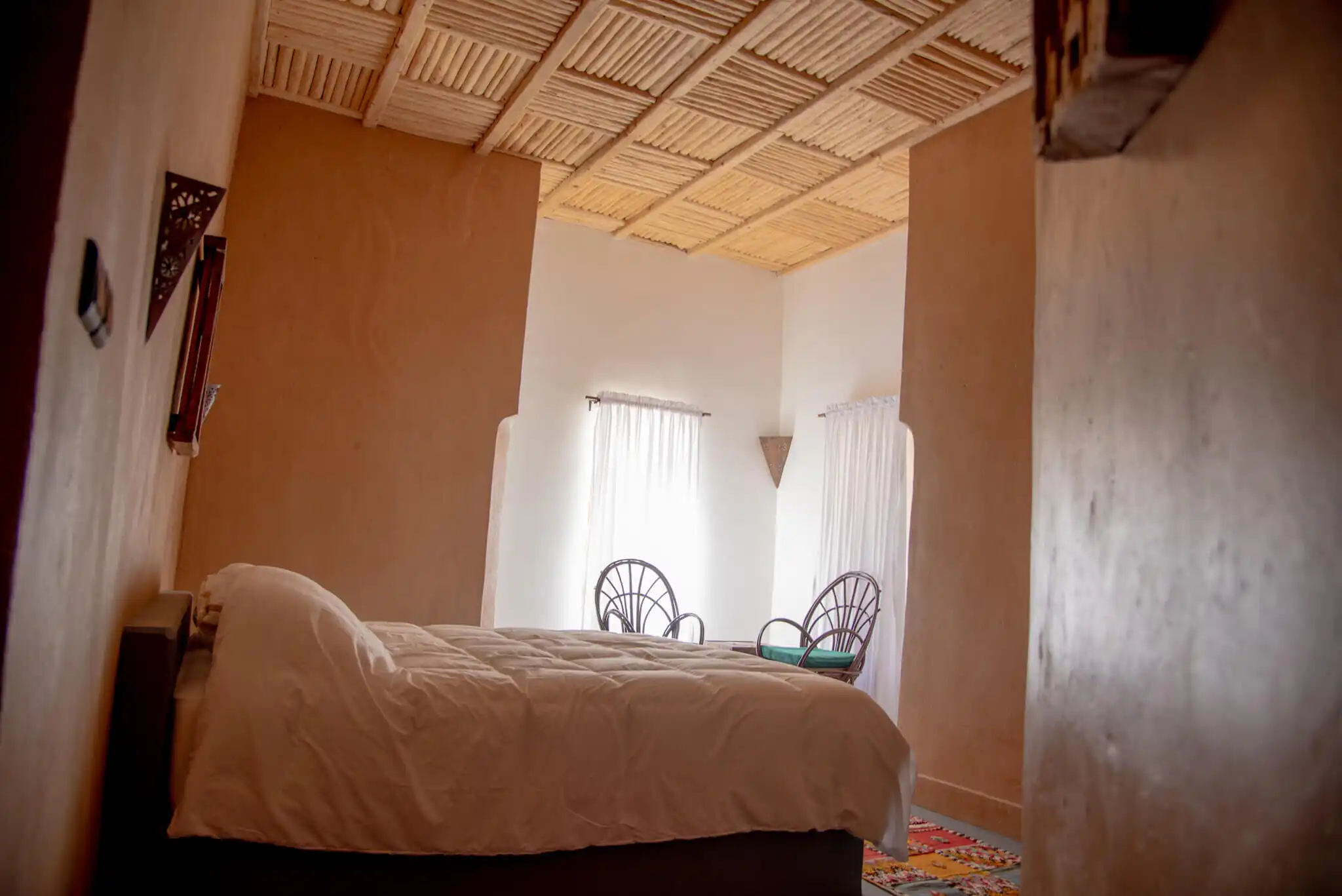 Bedroom at Kasbah Tiziri Hotel in Imzough, featuring traditional decor and natural lighting.