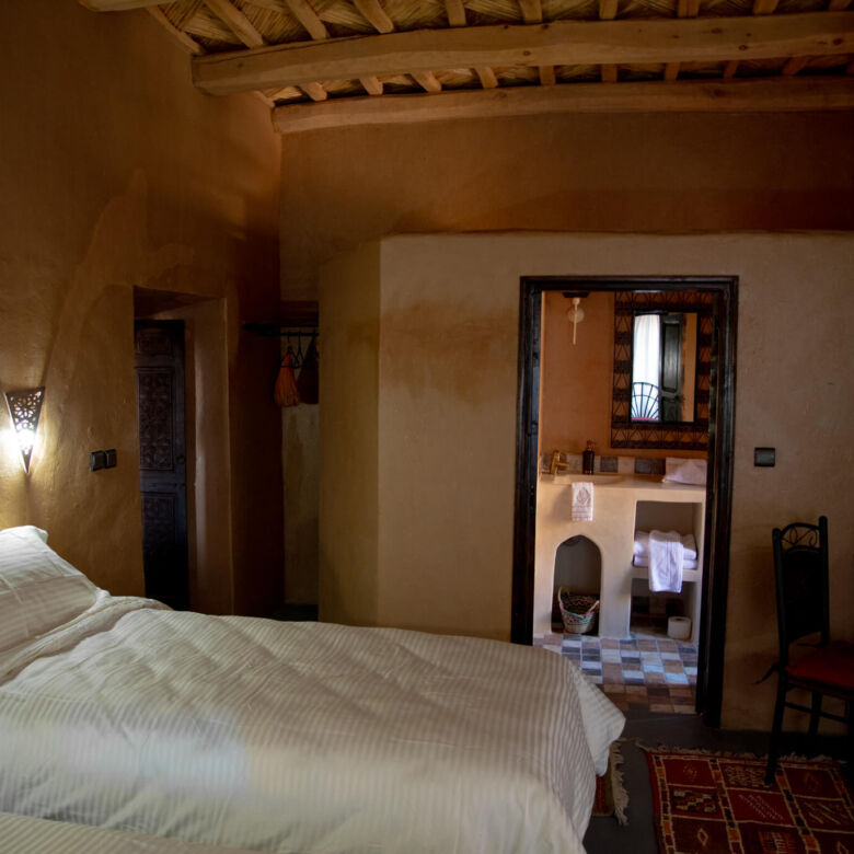 Hotel room at Kasbah Tiziri in Imzough, Morocco, showcasing traditional decor and cozy ambiance.