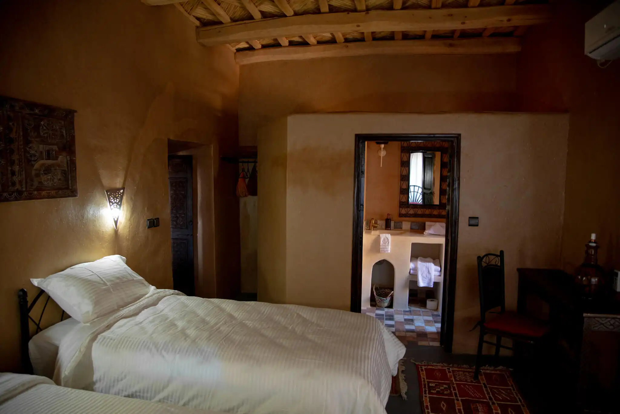 Hotel room at Kasbah Tiziri in Imzough, Morocco, showcasing traditional decor and cozy ambiance.