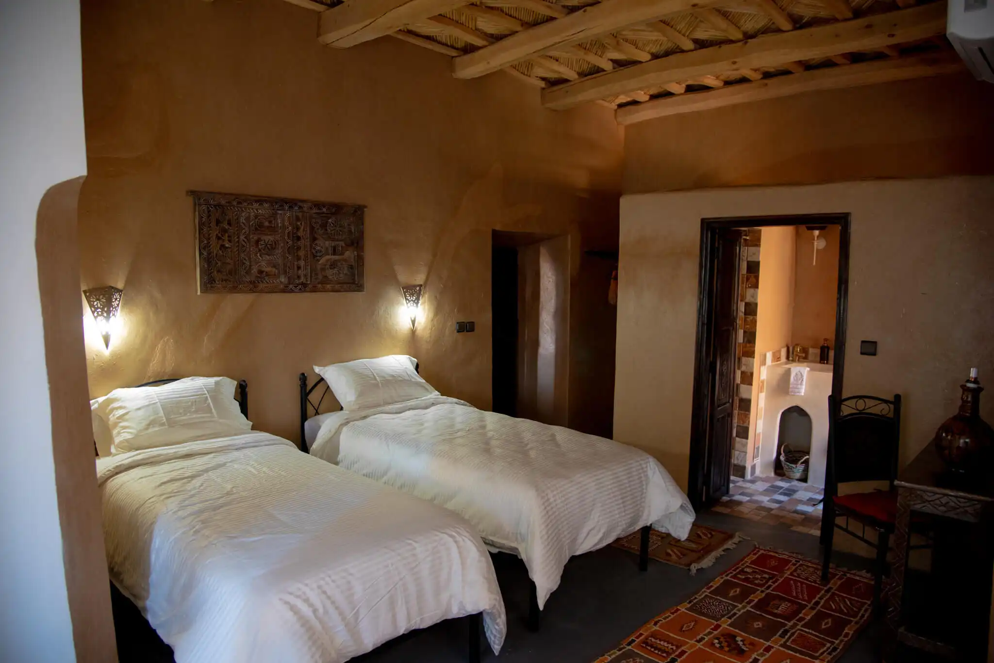 Hotel bedroom with two single beds and traditional decor.