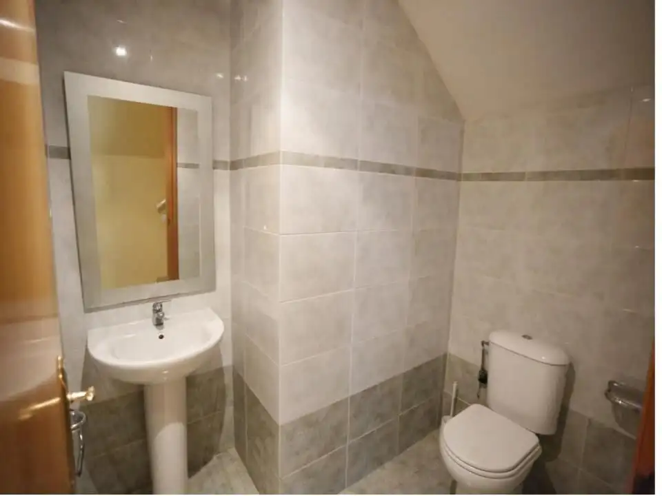 Small bathroom with sink and toilet in tourist apartment for 6/7 persons.