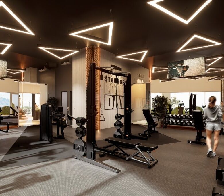 Modern gym in Tijuana luxury condos with stylish lighting and fitness equipment.