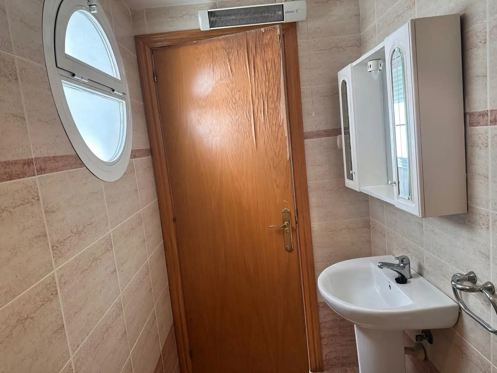 Bright bathroom with small window and modern sink.