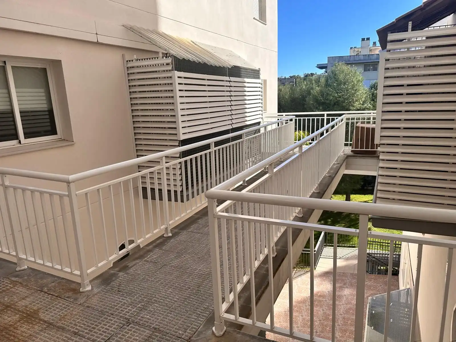 Balcony of a tourist apartment designed for 6/7 guests, featuring safety railings and outdoor seatin.