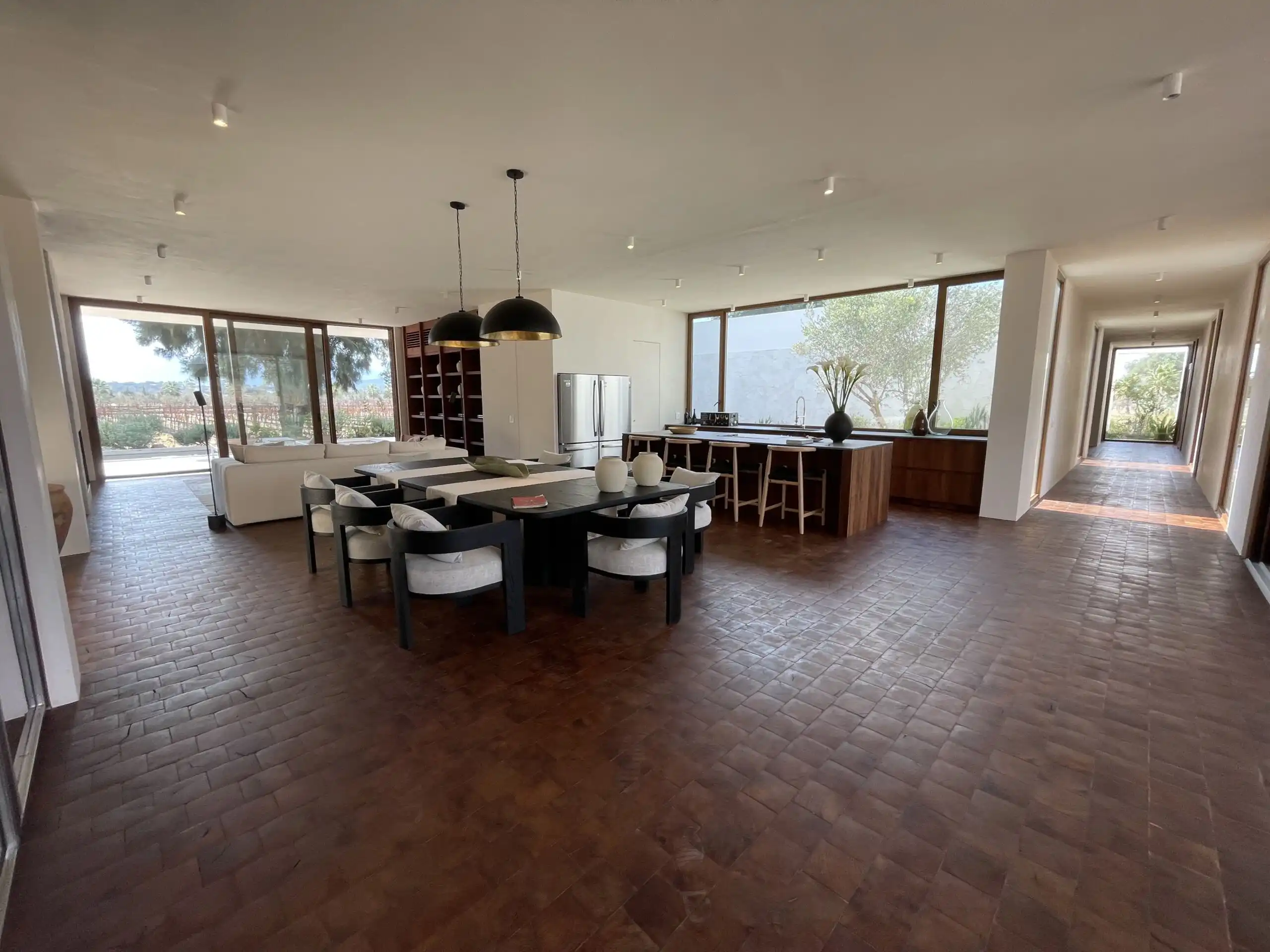 Luxury Vineyard Estate Interior Spacious modern dining and living area with large windows overlooking vineyards in San Miguel de All.