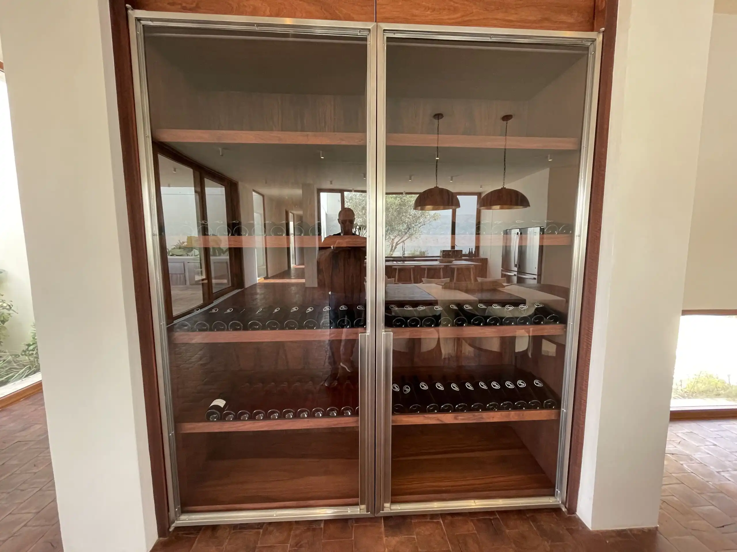 Luxury Vineyard Wine Cellar in San Miguel de Allende Elegant wine cellar with wooden shelves in a modern home in San Miguel de Allende.