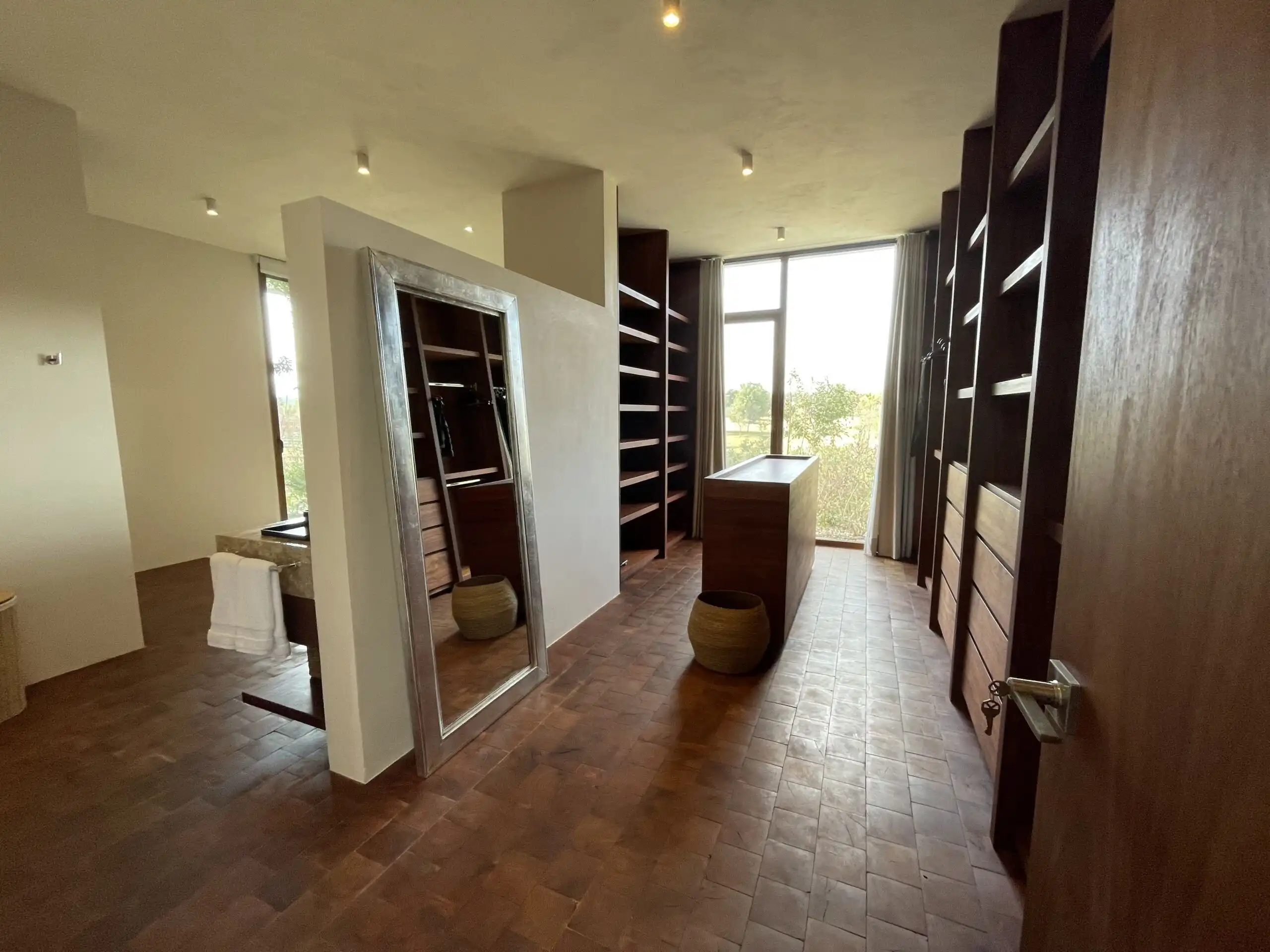 Luxury Vineyard Estate Interior Spacious wine cellar with wooden shelves and natural light in San Miguel de Allende.