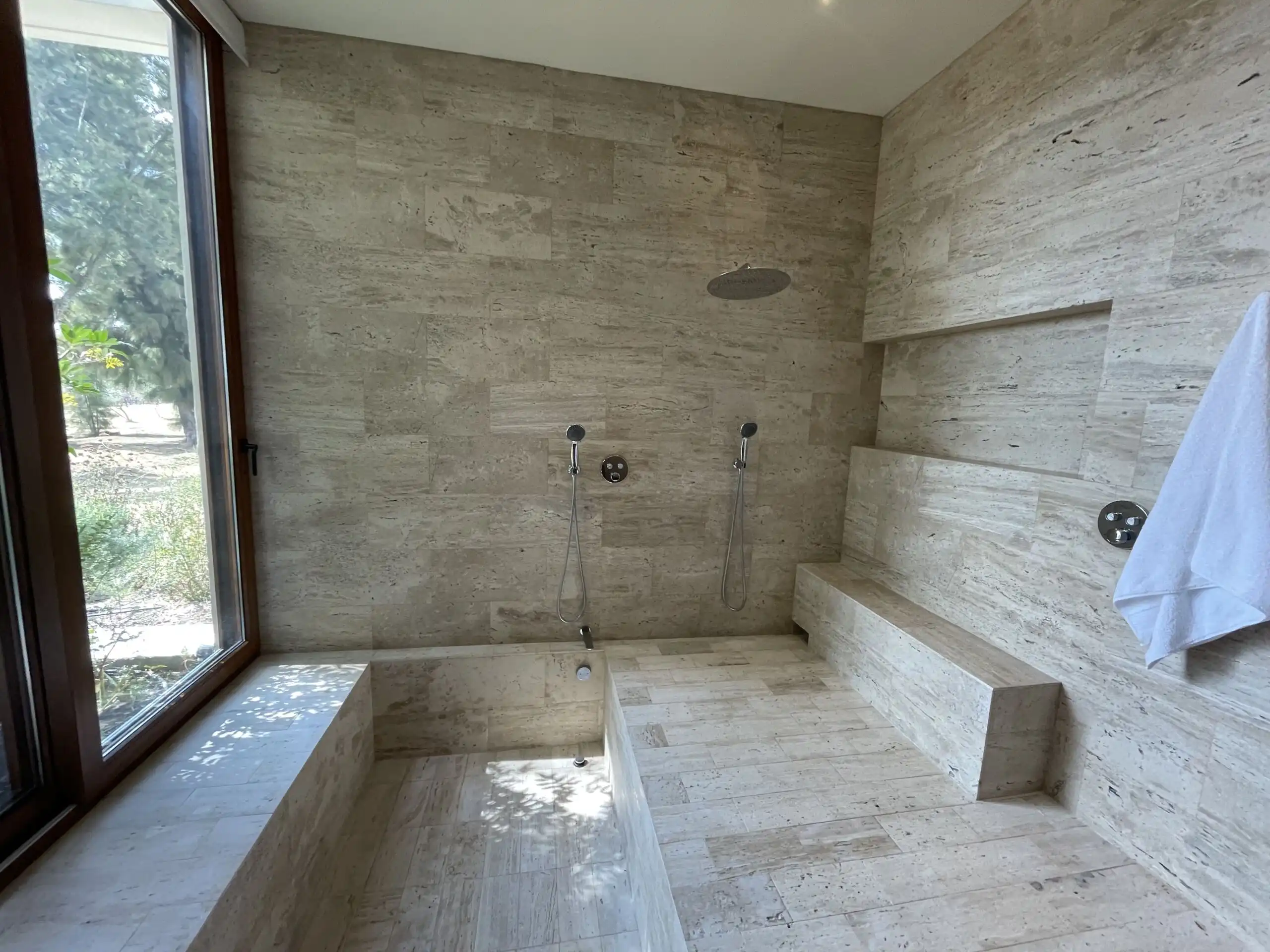 Luxury Vineyard Estate Bathroom Modern bathroom with stone finishes and dual showers in San Miguel de Allende.