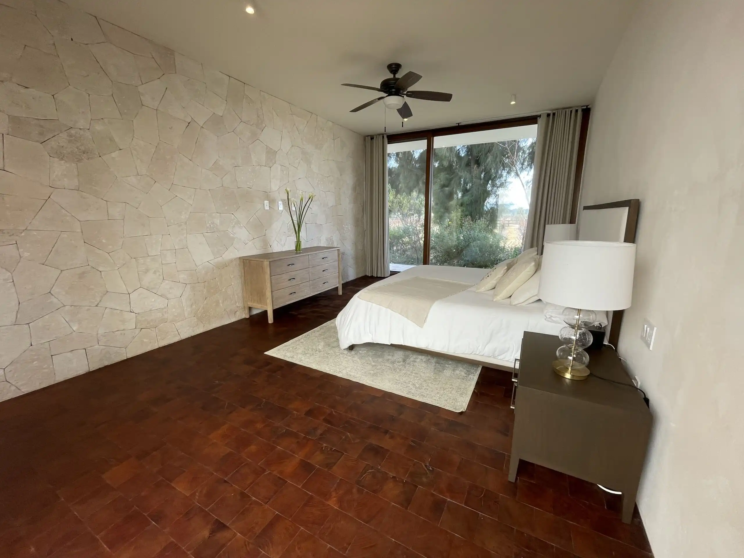 Luxury Vineyard Estate Bedroom Elegant bedroom with large window overlooking vineyards in San Miguel de Allende.