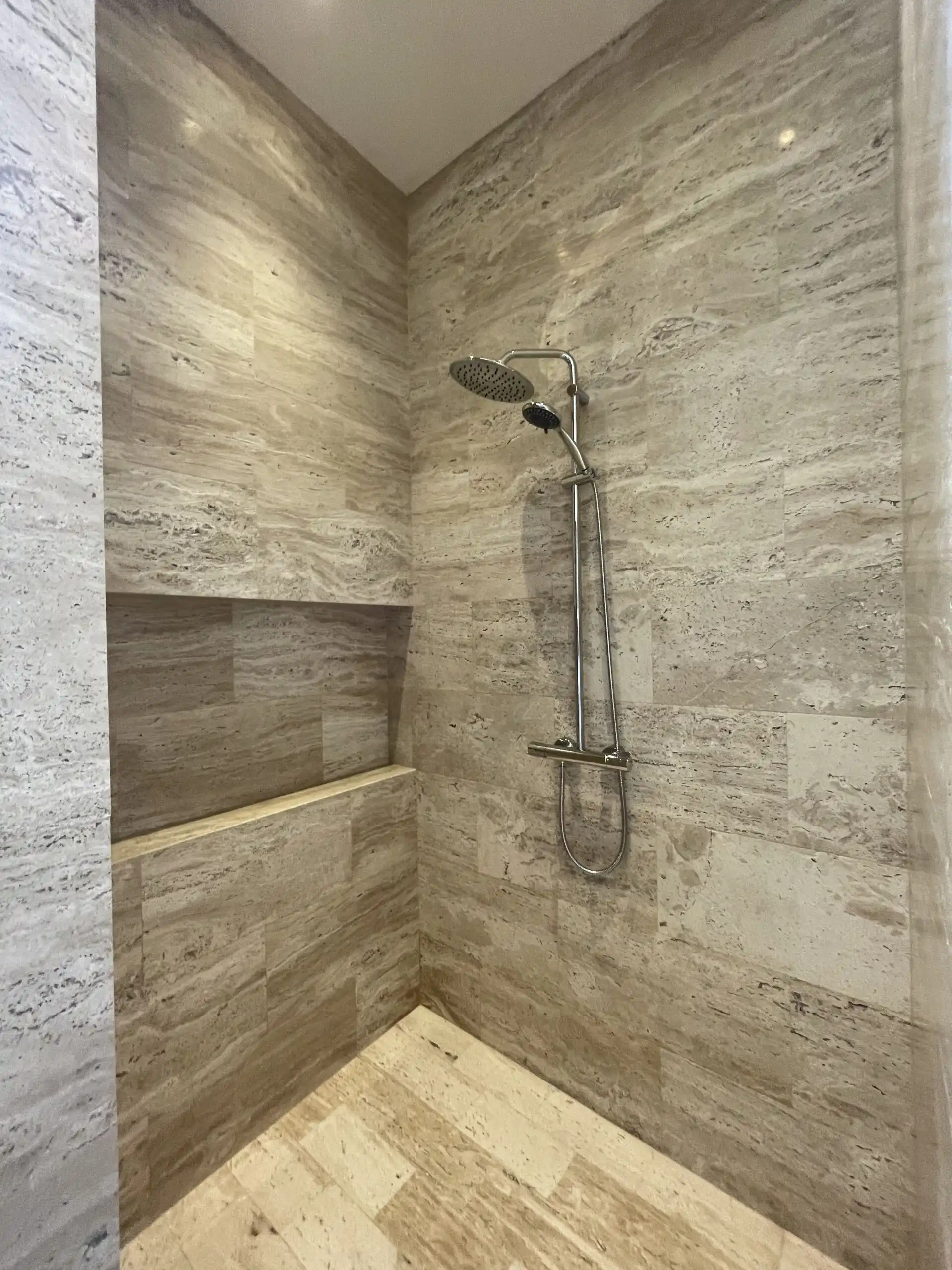 Luxury Bathroom Shower Area In shower with sleek fixtures in a spacious, elegant bathroom.