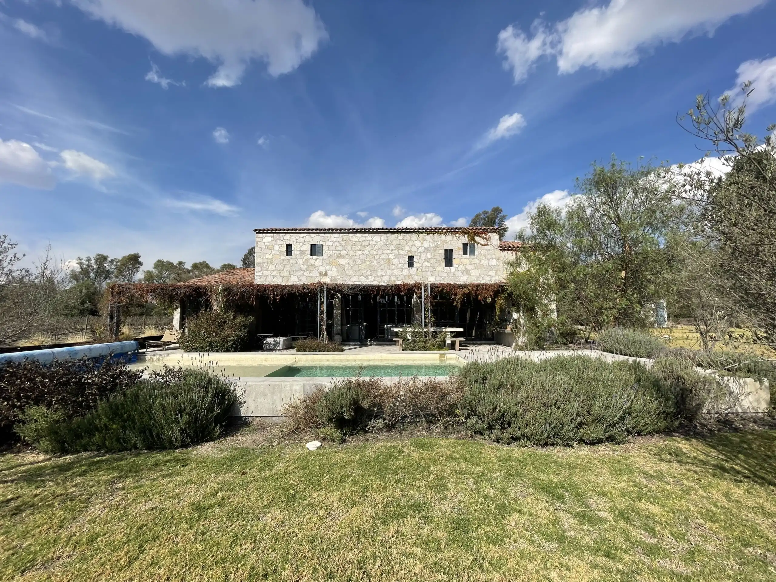 Elegant vineyard estate with modern architecture in San Miguel de Allende, featuring lush gardens an.