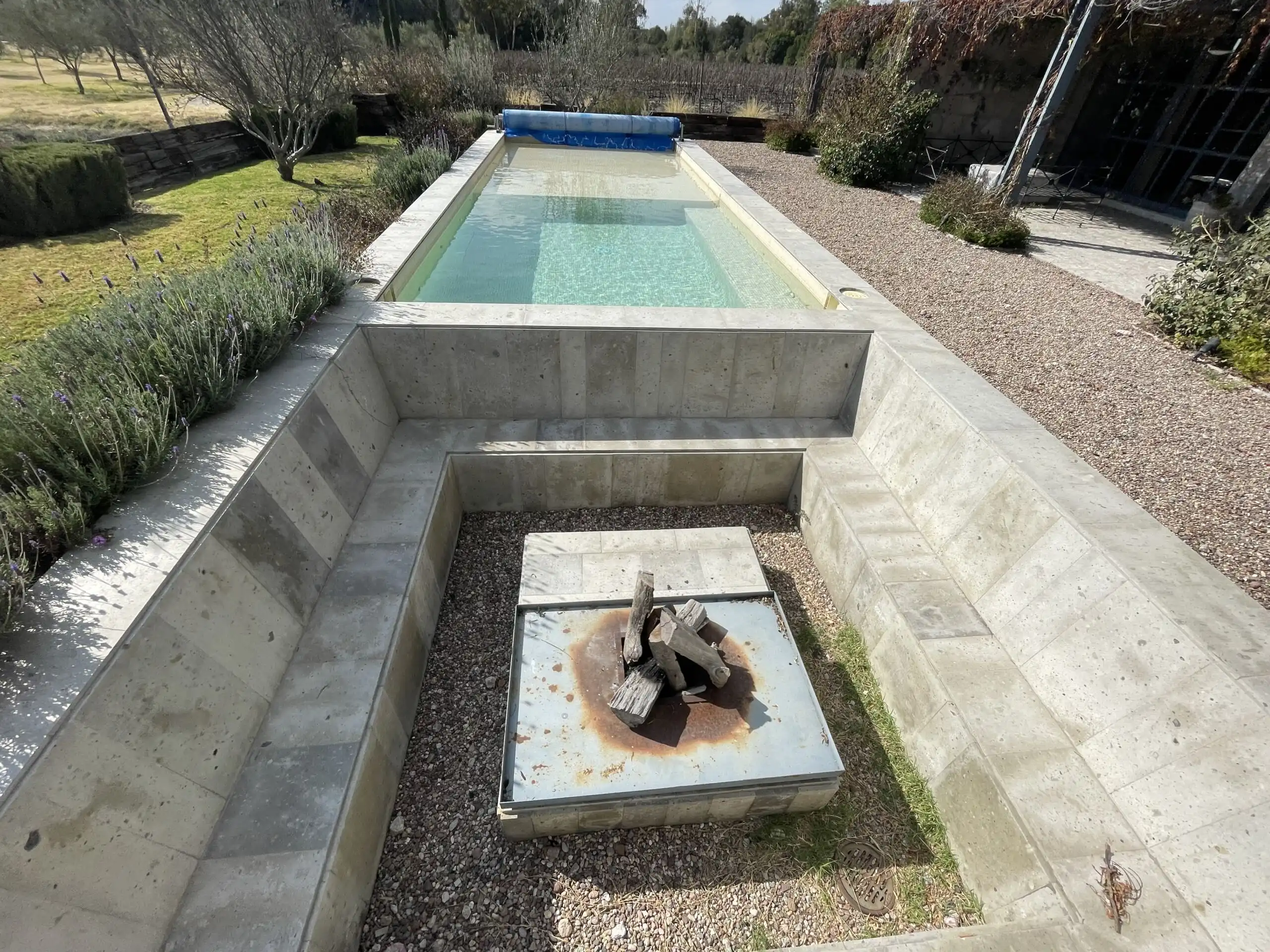 Modern outdoor pool with surrounding garden in a vineyard estate.