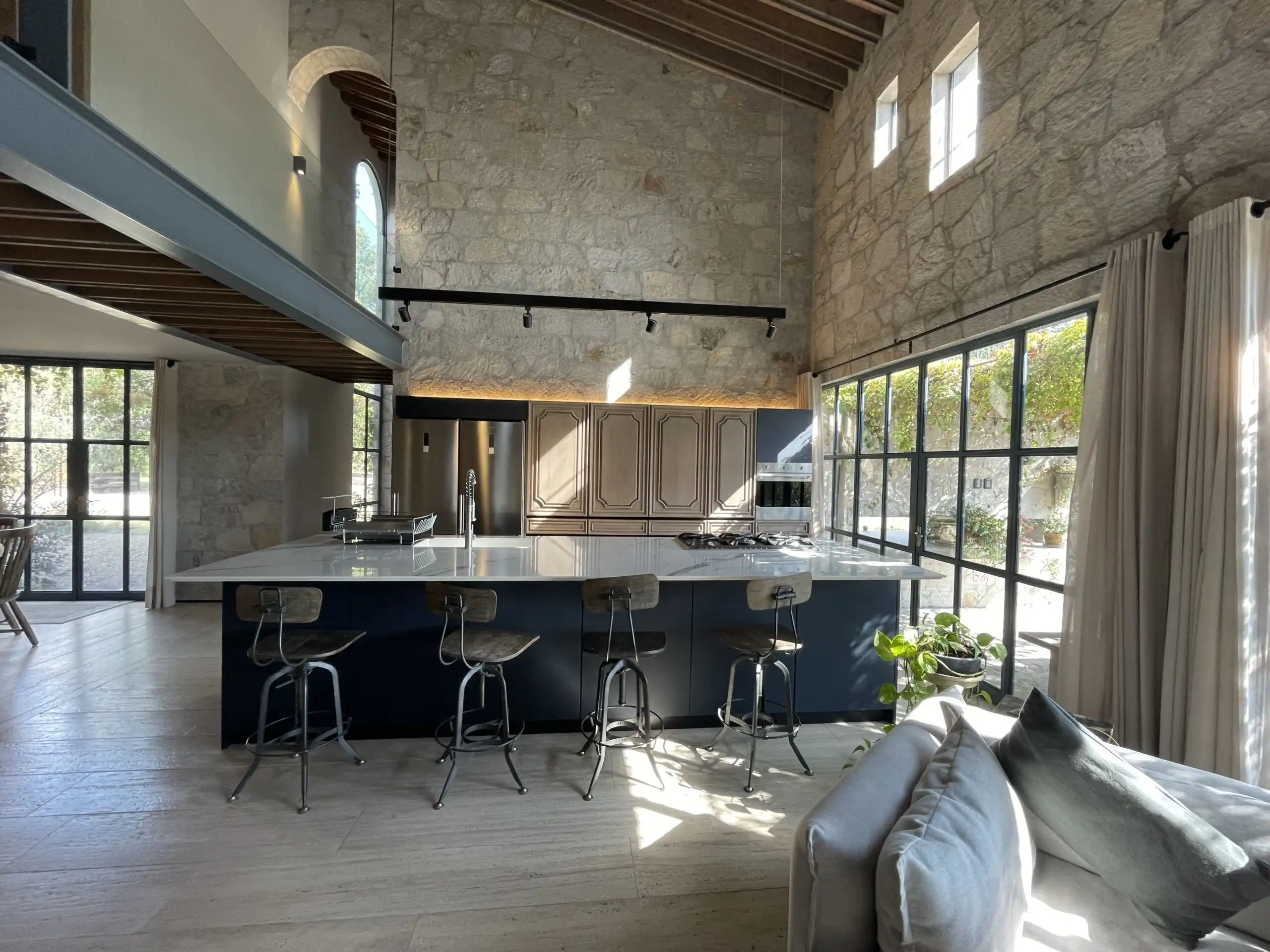 Elegant kitchen with large windows and modern appliances in a vineyard estate.