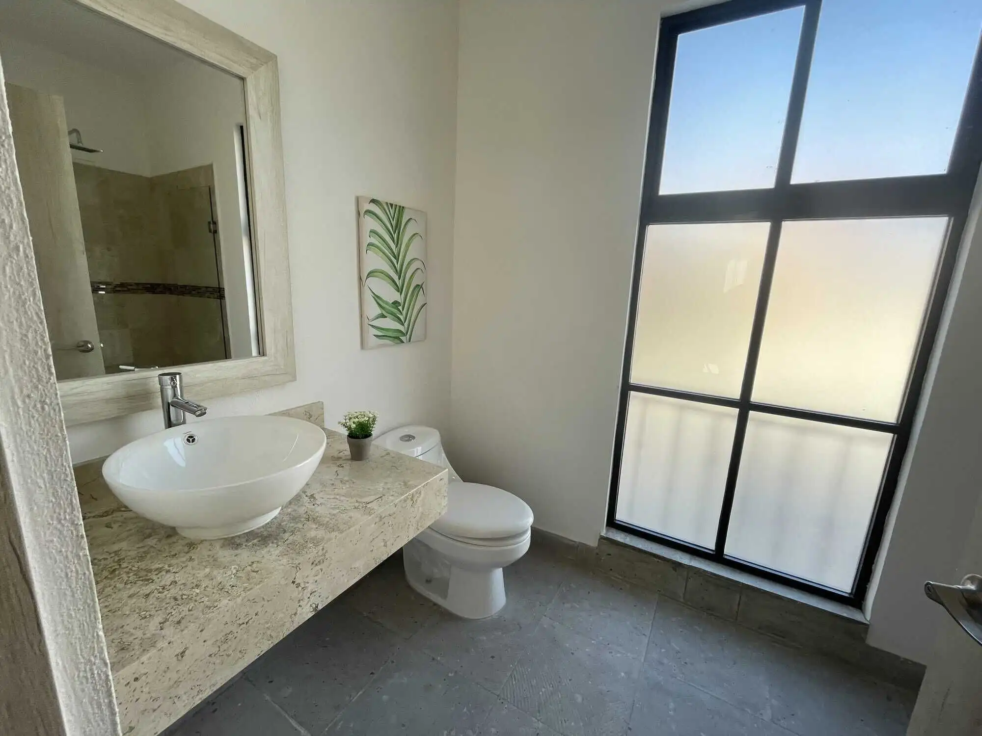 Bright bathroom with contemporary fixtures and natural light.