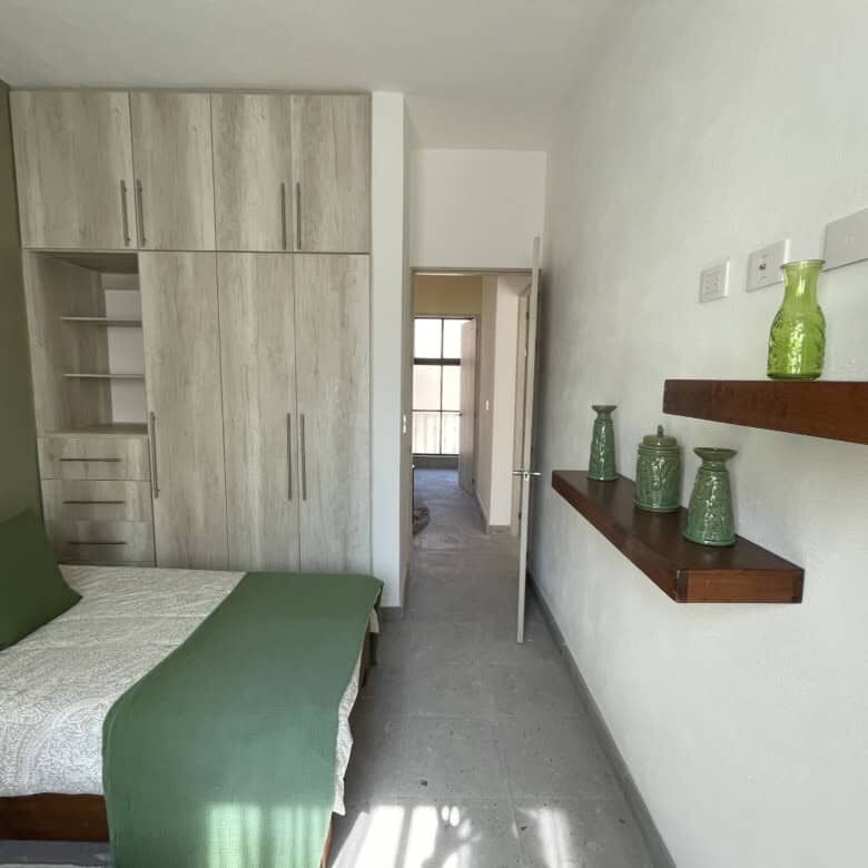 Cozy bedroom featuring a large wardrobe and stylish wall shelves in La Serena Residencial.