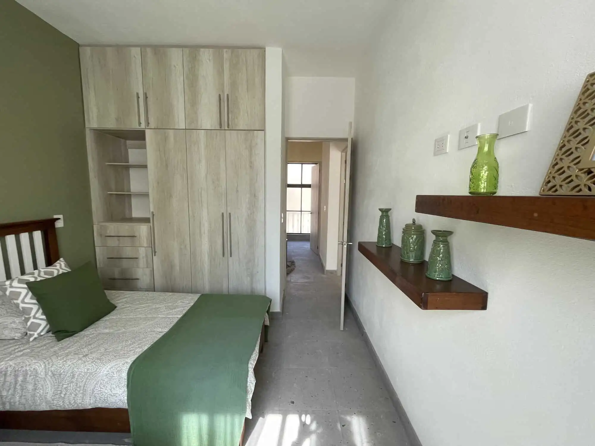 Cozy bedroom featuring a large wardrobe and stylish wall shelves in La Serena Residencial.