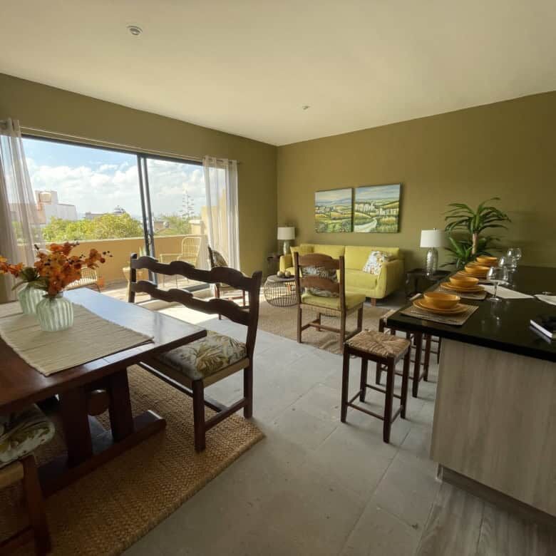 Bright living room with large window and contemporary decor in Santo Domingo home.