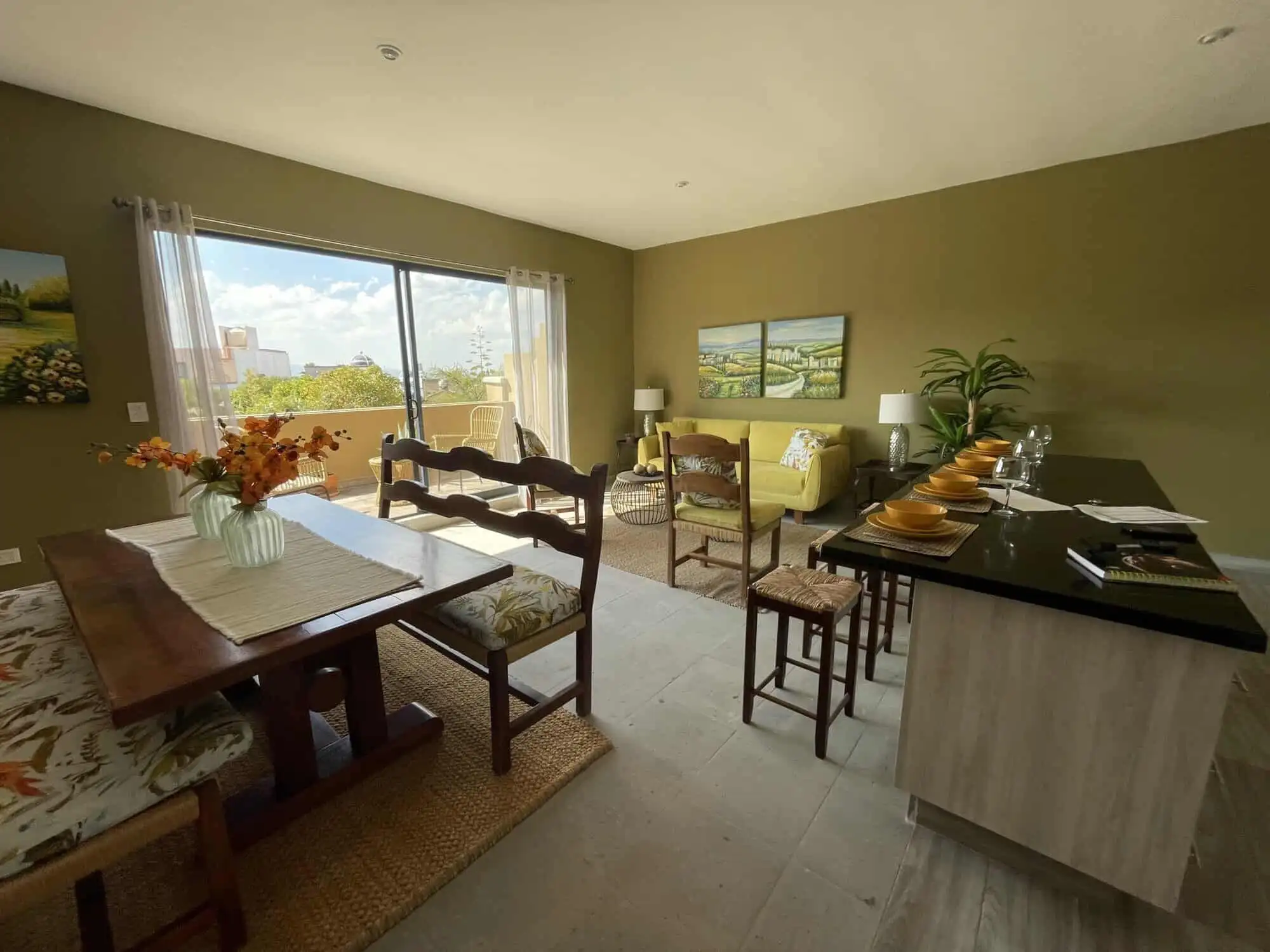 Bright living room with large window and contemporary decor in Santo Domingo home.