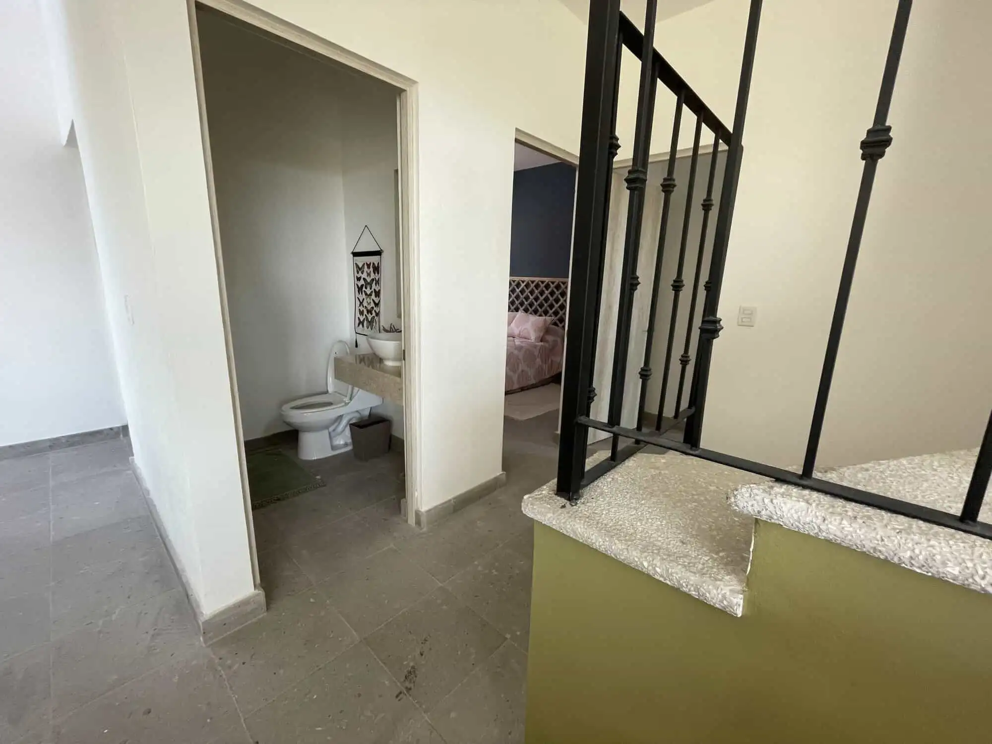 Modern interior staircase and bathroom in Santo Domingo home.