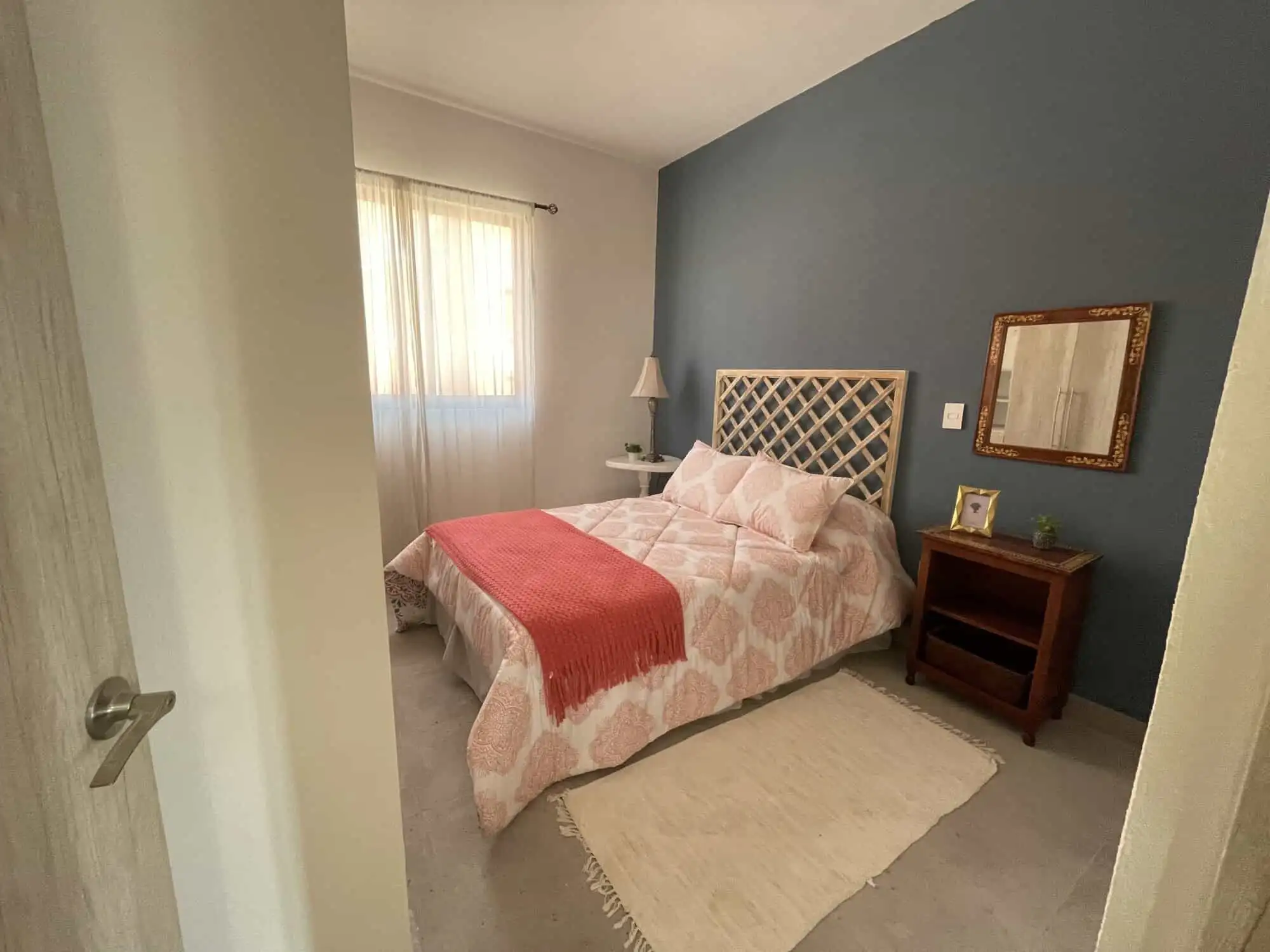 Bright bedroom with a comfortable bed and stylish decor in Santo Domingo. Perfect for relaxing in a.