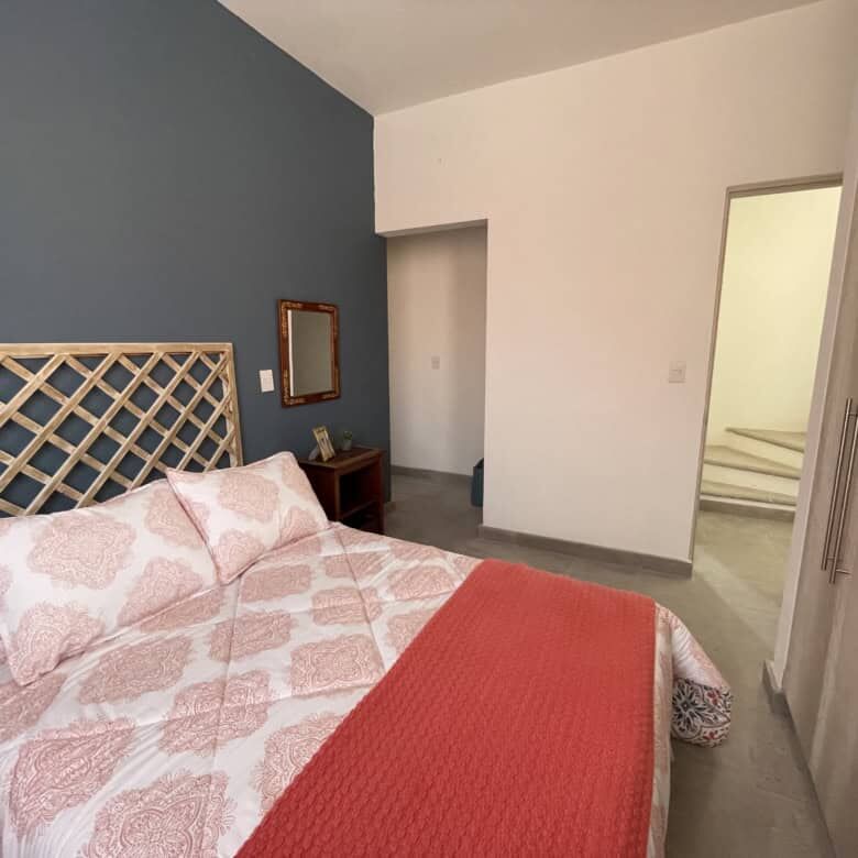 Comfortable bedroom with stylish decor in Santo Domingo home.
