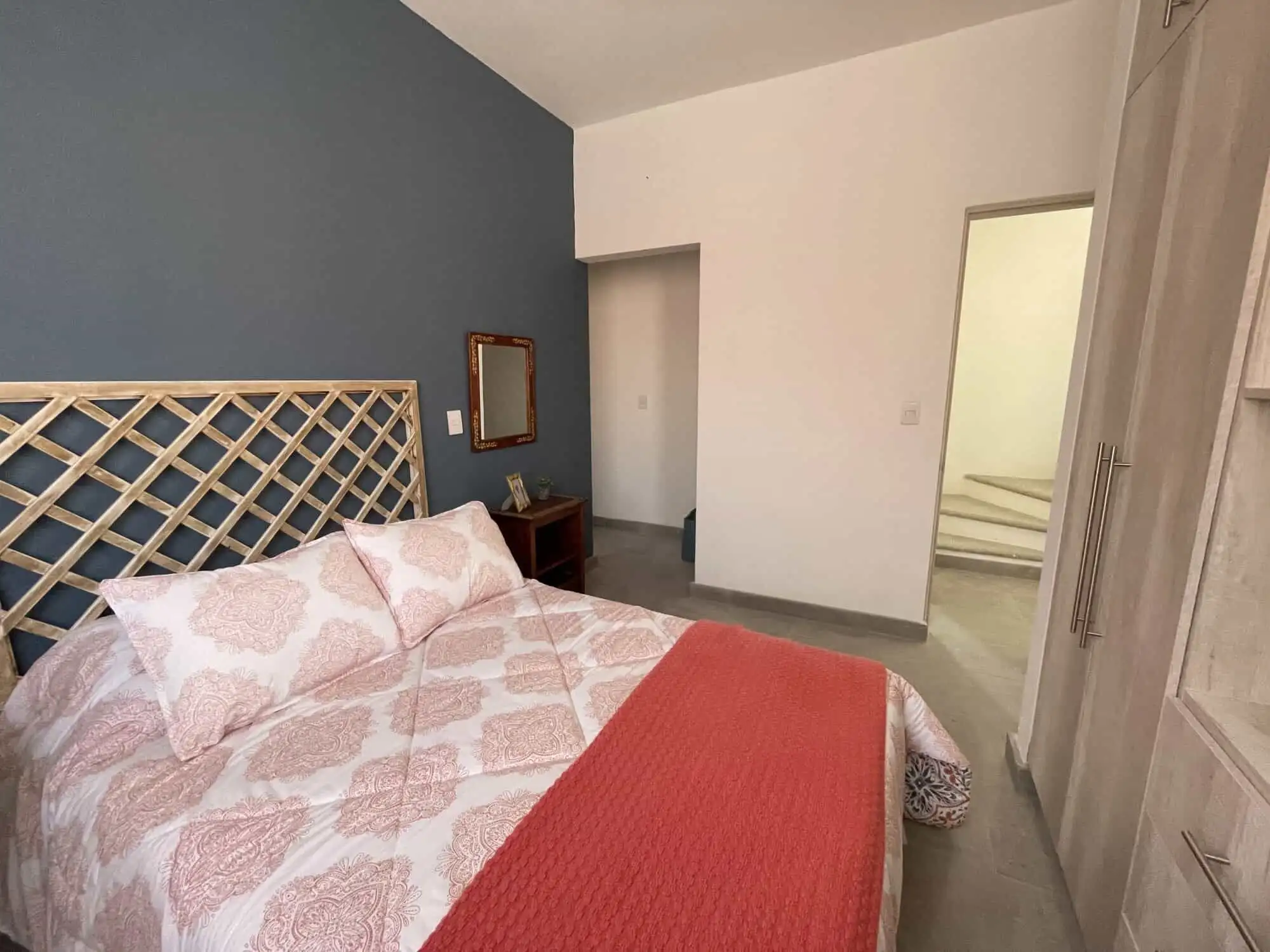 Comfortable bedroom with stylish decor in Santo Domingo home.