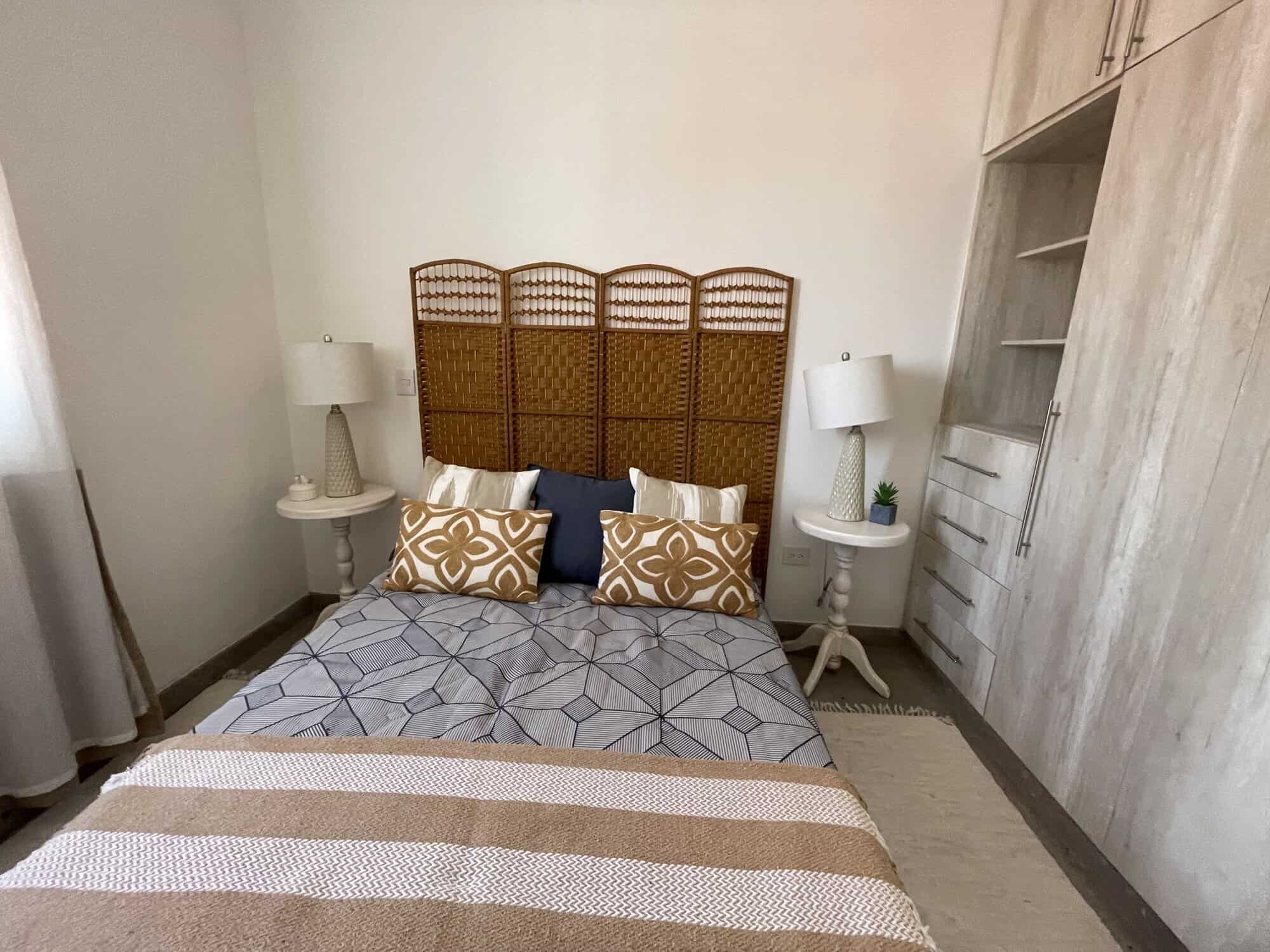 Modern Colonial Bedroom in Santo Domingo Cozy bedroom with modern decor and rattan headboard in Santo Domingo home.