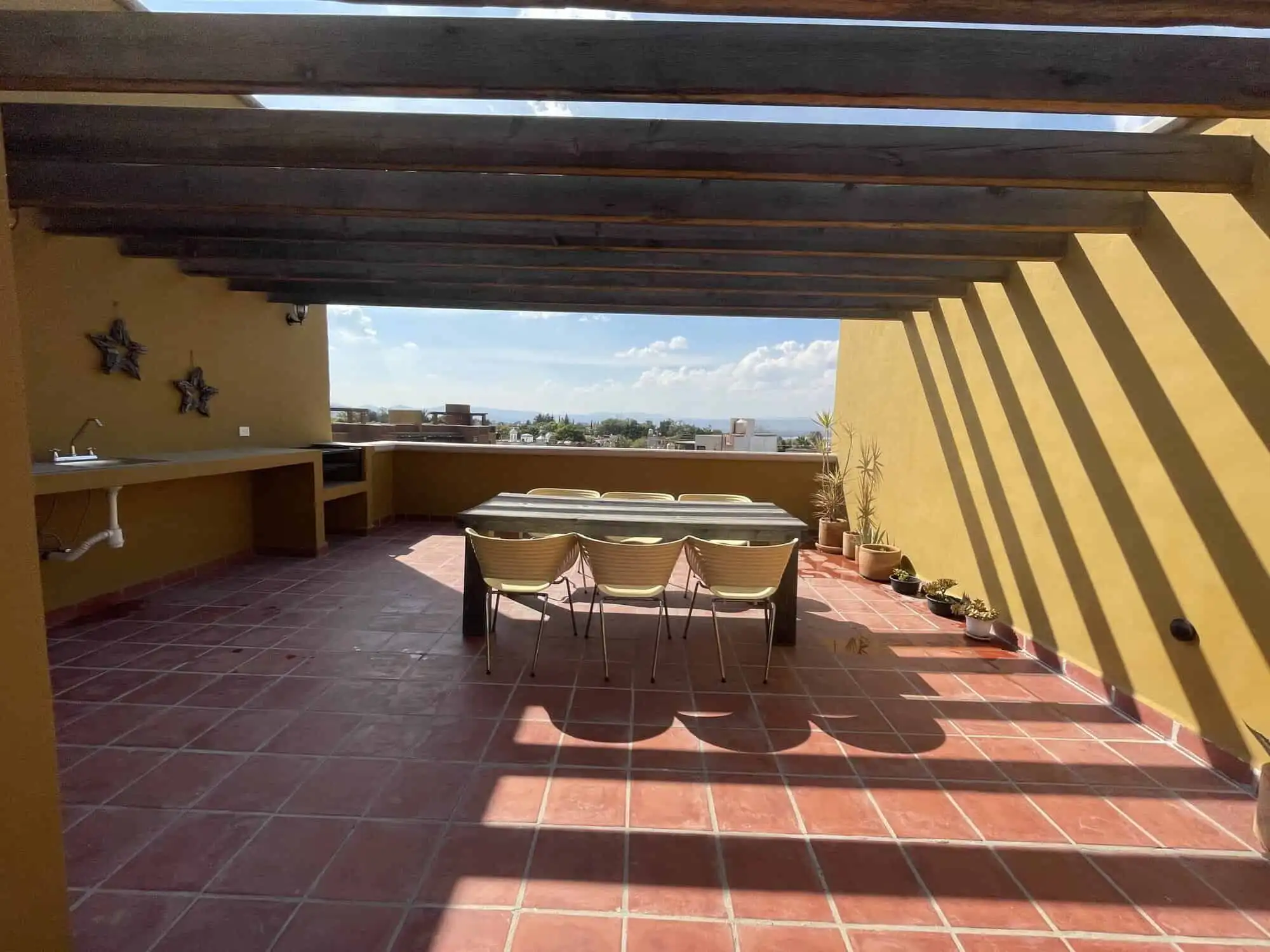 Spacious rooftop terrace with seating area and scenic city views in Santo Domingo home.